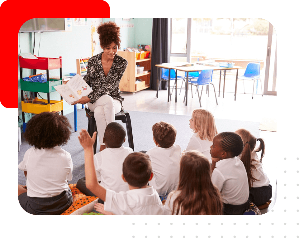 Teacher helping children read